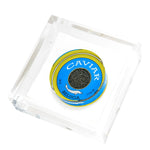 A tin of Beluga caviar with a blue and gold label is displayed on the Tara Wilson Designs Caviar Acrylic Cocktail Napkin Holder, blending elegance with functionality.
