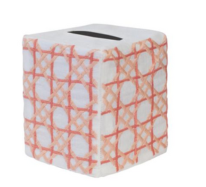 A square tissue box cover from the Cane Bath Collection by Haute Home, crafted from fine Italian linen in white and accented with an orange and pink crisscross pattern, is shown against a plain white background.