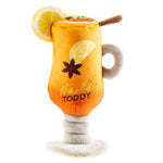 The Haute Toddy Dog Toy by Haute Diggity Dog features an adorable plush mug shaped like a hot toddy, complete with embroidered lemon slices, star anise, and “Haute Toddy” stitched on the front—making it the perfect cozy après-ski cuddle toy for your pup.