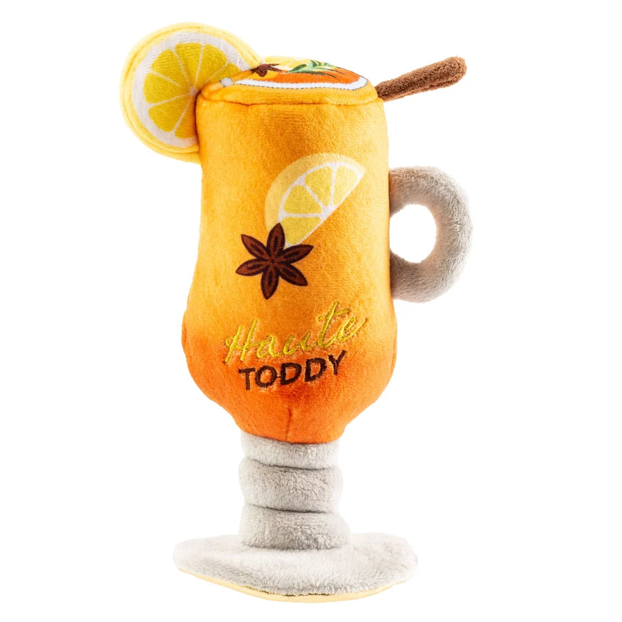 The Haute Toddy Dog Toy by Haute Diggity Dog features an adorable plush mug shaped like a hot toddy, complete with embroidered lemon slices, star anise, and “Haute Toddy” stitched on the front—making it the perfect cozy après-ski cuddle toy for your pup.