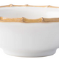 The Juliska Classic Bamboo Dinnerware Collection features a white ceramic bowl with a glossy finish and bamboo-inspired rim, bringing casual elegance and international flair to your table.