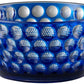 The Mario Luca Giusti Lente Acrylic Dinnerware Collection features a blue bowl with raised, rounded bumps—ideal for outdoor entertaining or pairing with other blue acrylic pieces for a stylish, coordinated setting.