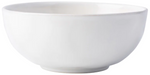 The Juliska Puro Whitewash Dinnerware Collection features a smooth, glossy ceramic bowl in crisp white—ideal for serving tapas or presenting teatime treats, seamlessly blending into any table setting with its versatile design.