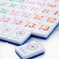 A close-up of Oh My Rummi Set tiles by Oh My Mahjong, showcasing vibrant numbered tiles and a Joker with multicolored dots—ideal for family game nights and fans of classic tile games.