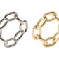 Two napkin rings from the Kim Seybert Chain Link Napkin Ring Collection—one in silver and one in gold—each crafted with six oval links, are displayed side by side on a white background, showcasing the elegant simplicity of chain-link design as a distinctive accent for your table setting.