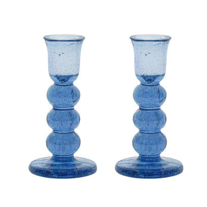 The Provence Candlestick Set by Juliska features blue mouth-blown glass with a rounded, stacked design and wide base—ideal for anyone who loves unique bubbly glassware.