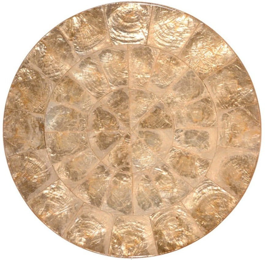 The Kim Seybert Capiz Placemat is a round, golden placemat with a textured, segmented design reminiscent of overlapping shells—an elegant decorative accent for your table.
