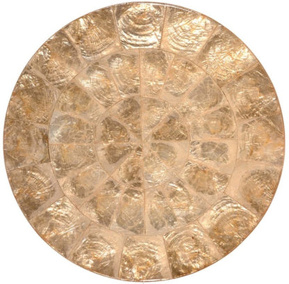 The Kim Seybert Capiz Placemat is a round, golden placemat with a textured, segmented design reminiscent of overlapping shells—an elegant decorative accent for your table.