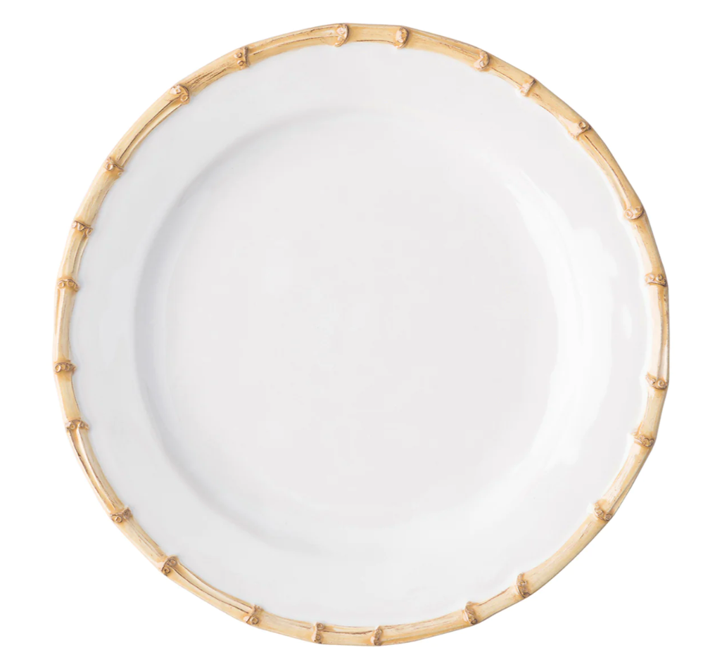A round white ceramic plate from the Juliska Classic Bamboo Dinnerware Collection, featuring a bamboo-patterned rim, is shown from above on a plain background for an elegant yet casual look.