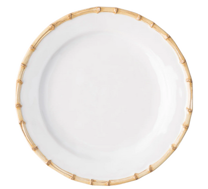 A round white ceramic plate from the Juliska Classic Bamboo Dinnerware Collection, featuring a bamboo-patterned rim, is shown from above on a plain background for an elegant yet casual look.