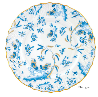 Round porcelain charger plate from Ginori 1735's Oro Di Doccia Turchese Dinnerware Collection, featuring blue and gold floral and bird motifs, a scalloped edge with hand-painted gold trim.
