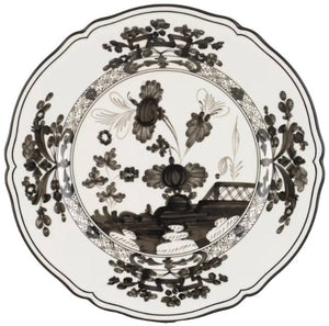 The Oriente Italiano Albus Dinnerware Collection by Ginori 1735 features porcelain plates with scalloped edges and intricate black floral and geometric designs on a white background, inspired by timeless elegance.