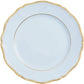 A white porcelain plate from the Raynaud Mazurka Or Fond Bleu Gris Dinnerware Collection, featuring a scalloped edge and a gold rim.