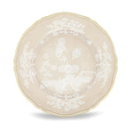 Beige porcelain plate from Ginori 1735’s Oriente Italiano Meringa Collection, featuring scalloped edges, gold trim, and white floral and landscape motifs at the center and rim.