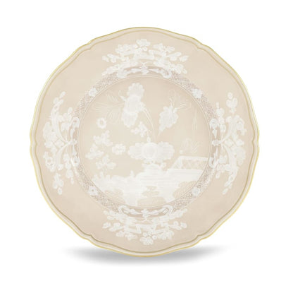 Beige porcelain plate from Ginori 1735’s Oriente Italiano Meringa Collection, featuring scalloped edges, gold trim, and white floral and landscape motifs at the center and rim.