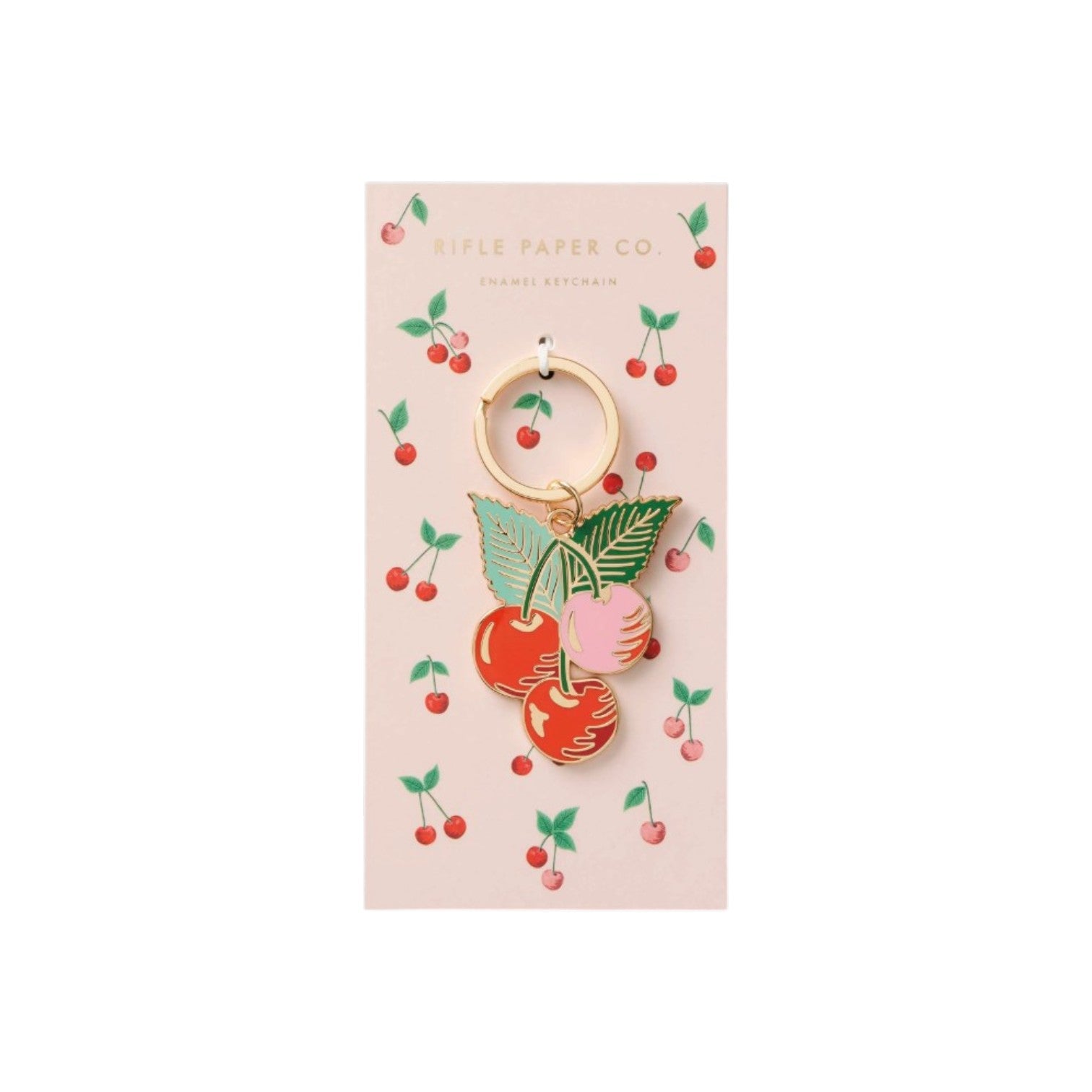 The Cherries Collection keychain by Rifle Paper Co. features a cherry and leaf enamel design on a gold keyring, displayed on a matching cherry-patterned card—ideal for cherry collectors or fans of orchard-inspired decor.