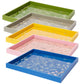 The Addison Ross Medium Chinoiserie Tray Collection features five high-gloss lacquer trays in green, gray, yellow, pink, and blue with floral and bird designs, stacked in a staggered display.