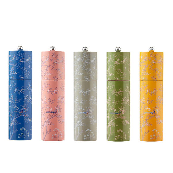 Five colorful cylindrical mills from the Addison Ross Chinoiserie Salt and Pepper Mill Collection are arranged in a row, featuring floral patterns in blue, pink, gray, green, and yellow with silver caps and ceramic grinding mechanisms.