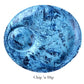 The Nashi Home Denim Resin Serveware Collection features a round blue marbled chip and dip serving plate with a built-in dip section—shatter resistant and perfect for stylish home decor.