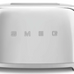A silver SMEG 2-Slice Toaster Collection with wide slots and the word "Smeg" on it.