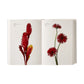An open book from Phaidon’s Flower Color Guide displays labeled photographs of red flowers on white pages—ideal for exploring and identifying flower types by color.