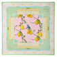 The Oh My Mahjong Mahjong Mat Collection silk square scarf features lemons and a bird on branches at the center, bordered by Capri-inspired pastel green and yellow geometric patterns with labeled sections referencing mahjong tiles.