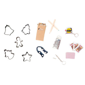 Assorted items like cookie cutters, colored pencils, a cheese grater, tape measure keychain, playing cards, star magnet, and mini screwdriver—ideal as fillers for Caspari's Christmas Trees with Lights Crackers or as festive luxury embellishments.