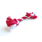 A Caspari Santa Hat Cat Cracker pet toy, red and white with knotted ends, shaped like a cracker, shown on a white background.