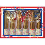 Six gold and white Caspari Celebrate! Crackers with star and firework designs, decorated with colorful curly ribbons in a festive box—perfect party favors filled with surprises.