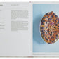 An open copy of "Classic French Recipes" by Phaidon displays a clafoutis recipe on the left page and a beautifully baked clafoutis with berries served in an oval dish on the right page, perfectly capturing the essence of authentic French home-cooking.