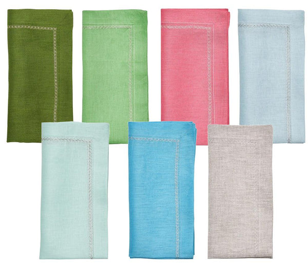 The Kim Seybert Classic Napkin Set by Kim Seybert includes seven linen napkins in dark green, light green, pink, red, light turquoise, blue, and beige. Each features an embroidered border and is displayed in two neat rows on a white background.