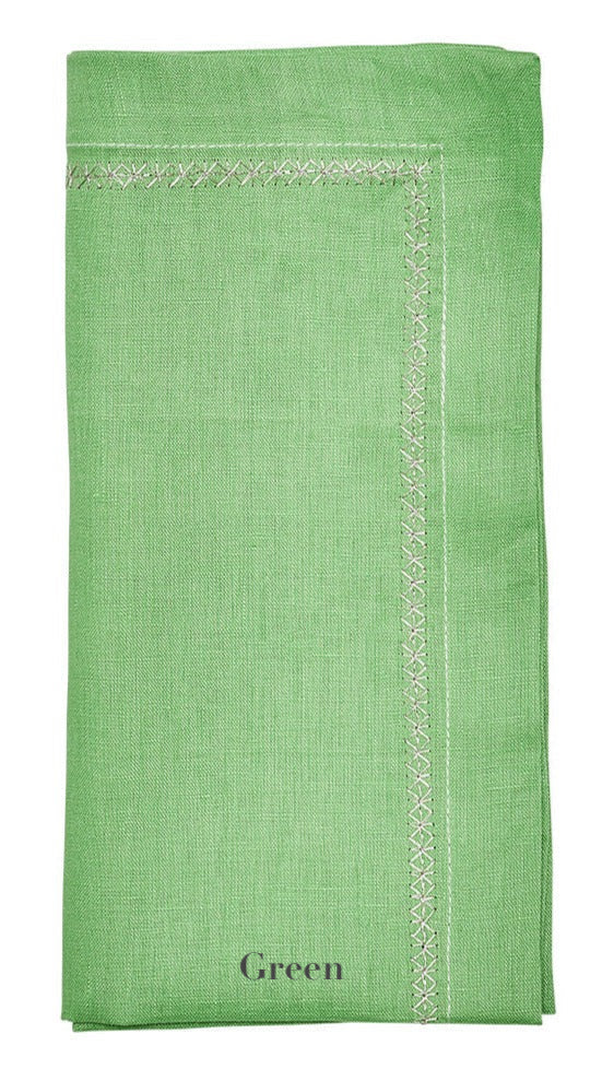 The Kim Seybert Classic Napkin Set by Kim Seybert includes a green linen napkin with visible stitching, "Green" elegantly printed at the bottom, and an embroidered border for timeless charm.