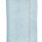 The Kim Seybert Classic Napkin Set features light blue linen napkins, elegantly labeled "Sky," with decorative stitching along the edges reminiscent of an embroidered border.