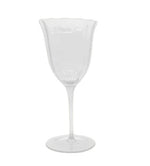 A clear wine glass from the Duggan Society’s Lily Collection, featuring a scalloped rim and long stem, set against a white background—an exquisite example of elegant tableware.