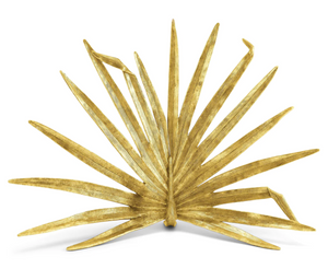 The Michael Aram Palm Decorative Fireplace Screen features a stylized, fanned-out palm leaf design with elongated segments and an antique gold finish.
