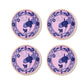 Four round porcelain plates from Ginori 1735's Oriente Italiano Azalea collection, featuring pink backgrounds, blue floral and geometric patterns, and yellow rims, are arranged two-by-two on a white surface. Perfect for elevating home decor.