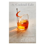 The cover of "The Cocktail Edit" by Chronicle Books features a cocktail glass with an orange peel and large ice cube, highlighting this essential guide to classic cocktails and home bar drinks.