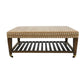 The Lee Industries Upholstered Cocktail Ottoman features an arrowhead patterned fabric, wooden legs with small wheels, and a lower slatted shelf.