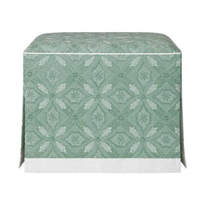 The Hickory Chair Cocktail Ottoman features a green and white patterned fabric cover with geometric and floral motifs, a dressmaker skirt for added elegance, and a white base trim. Made to measure for your unique space.