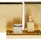 The Mancora Bath Collection by Pigeon & Poodle features shiny brass accessories, including a wastebasket, toothbrush holder, tray, soap dispenser, tissue box cover, lidded container, and soap dish.