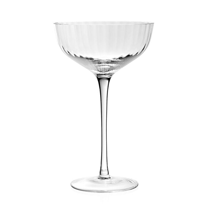 The Corinne Collection coupe glass by William Yeoward Crystal features a wide, shallow bowl with an elegant pattern and a long, slender stem, set against a plain white background.