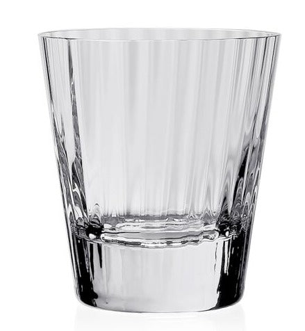 A clear, empty Corinne Collection tumbler by William Yeoward Crystal, featuring a vertical optic design, stands on a plain white background.