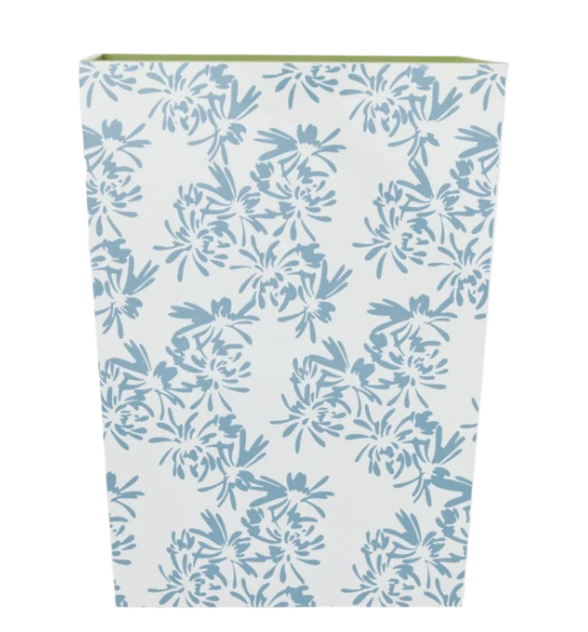 The Weezie Towels x Meg Braff Cornflower Bath Accessories wastebasket is adorned with Madame Butterfly's blue floral design, adding a touch of Palm Beach charm.