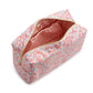 The LUXE Everyday Cosmetic Bag, Marseille by TRVL Design is a rectangular vegan leather pouch with a pink, blue, and white floral pattern. The partially open bag has a pink and white striped lining—ideal for organizing your toiletries in style.