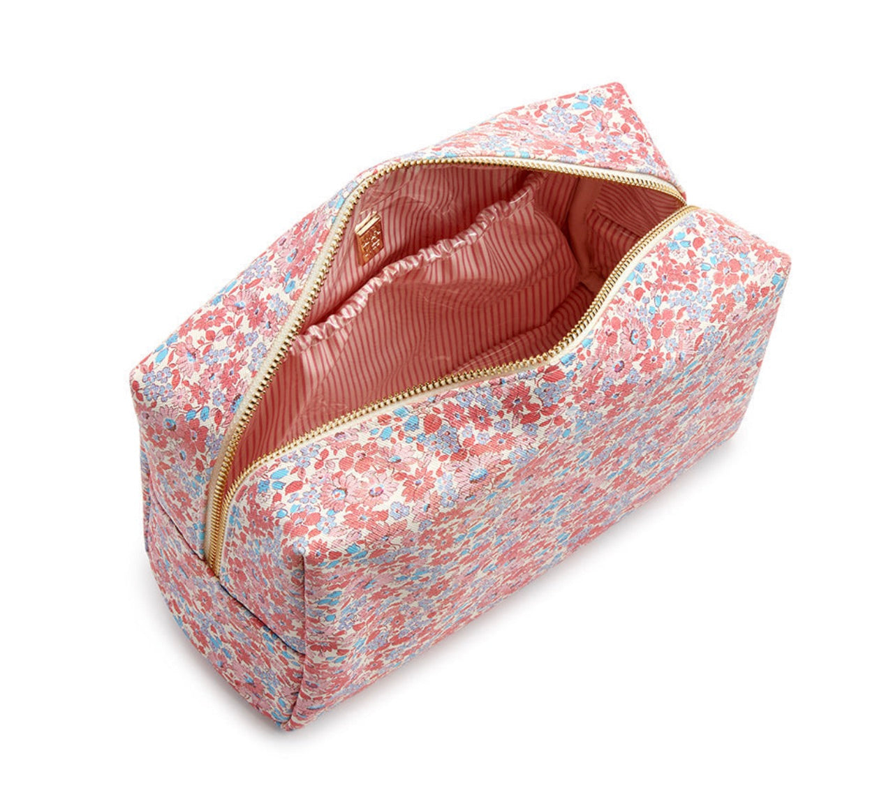 The LUXE Everyday Cosmetic Bag, Marseille by TRVL Design is a rectangular vegan leather pouch with a pink, blue, and white floral pattern. The partially open bag has a pink and white striped lining—ideal for organizing your toiletries in style.