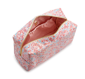 The LUXE Everyday Cosmetic Bag, Marseille by TRVL Design is a rectangular vegan leather pouch with a pink, blue, and white floral pattern. The partially open bag has a pink and white striped lining—ideal for organizing your toiletries in style.