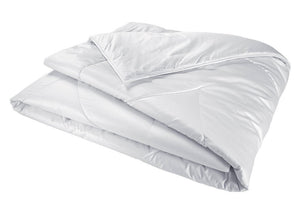 The Yves Delorme Mandarin Silk Comforter, featuring a smooth, quilted surface, is displayed against a plain white background.