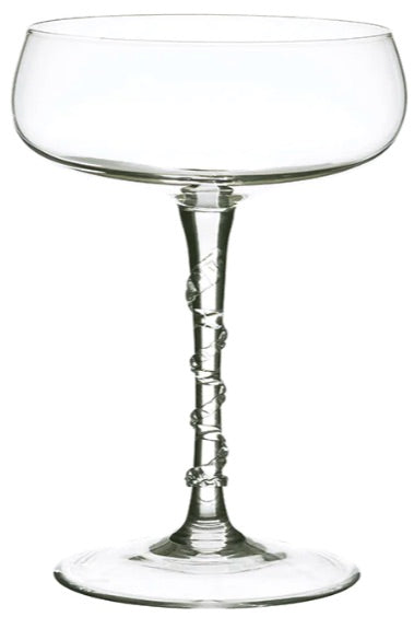 A clear coupe glass from the Juliska Amalia Drinkware Collection with a twisted stem and detailed base, displayed empty against a white background.