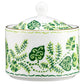 The Cobblers Cove Calypso sugar bowl by Royal Crown Derby features vibrant green leafy vine patterns and a round lid knob, perfect for bringing a Caribbean-inspired touch to your table.