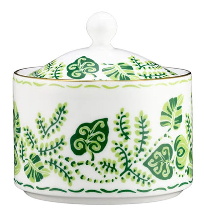 The Cobblers Cove Calypso sugar bowl by Royal Crown Derby features vibrant green leafy vine patterns and a round lid knob, perfect for bringing a Caribbean-inspired touch to your table.